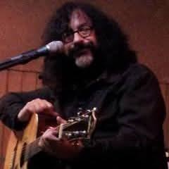 Guy Schwartz playing acoustic guitar